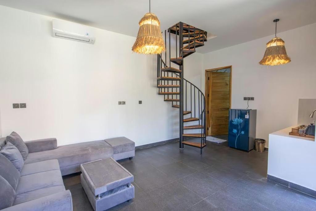 Villa living room with spiral staircase